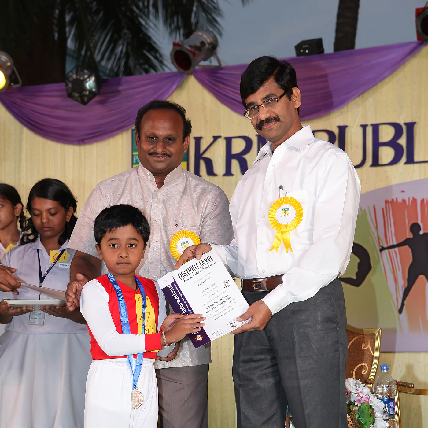 A student receiving a certificate at a KRM prize day