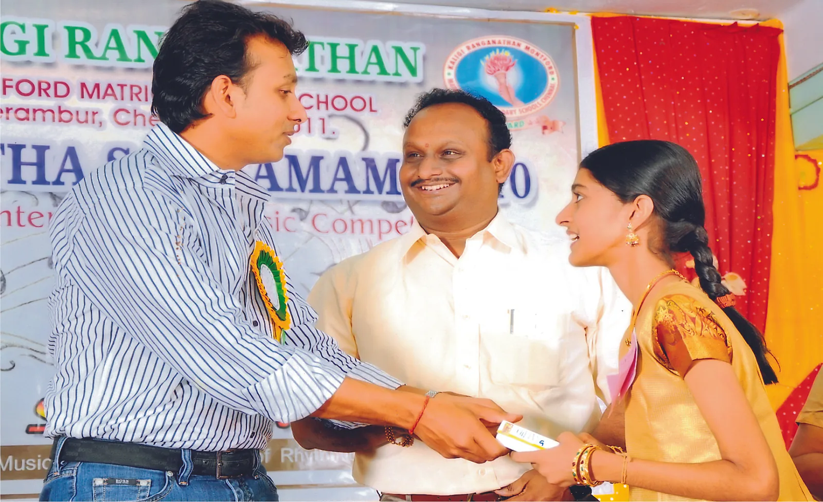 R.J. Bhuvanesh presenting a certificate to a student
