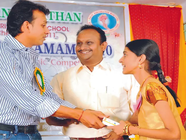Presenting a certificate at a school competition. A photograph of R.J. Bhuvanesh from the KRM Group of Schools archive