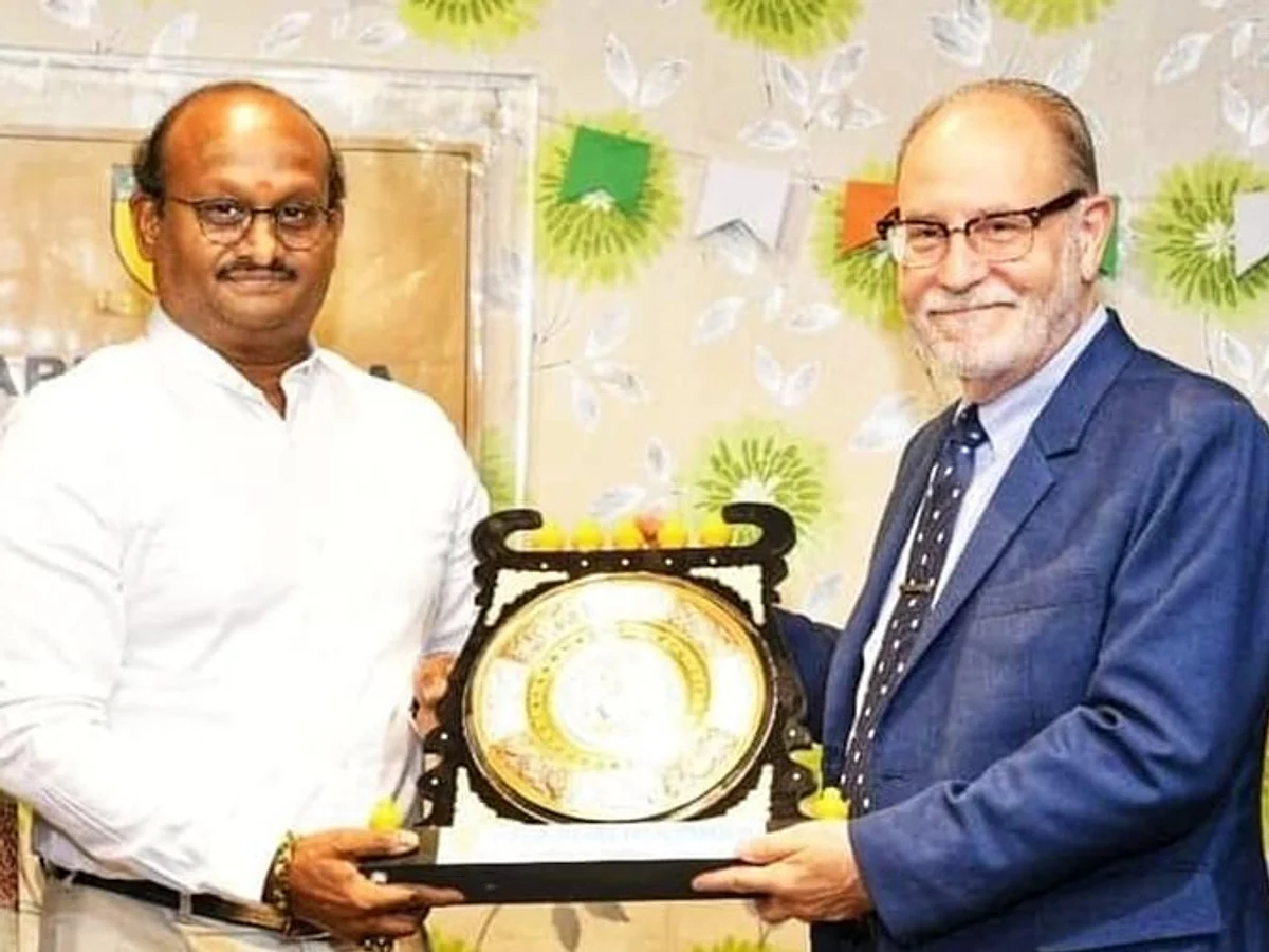 R.J. Bhuvanesh and a visiting guest holding a memento at a KRM school event
